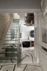 a staircase in a house with a glass stair case at BDB Rooms Margutta in Rome