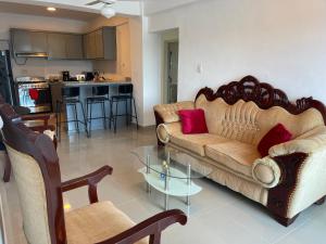 a living room with a couch and a glass table at Plataview Apartahotel apt 3A in Monte Plata