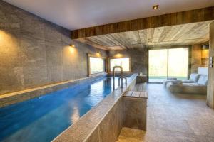 a swimming pool in a house with a large room at Chalet - Chalets 101 in Notre-Dame-de-Bellecombe