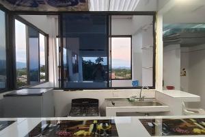 a kitchen with a sink and a stove and windows at !Vista panorámica en Lérida! in Lérida