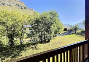 a balcony with a view of a field and trees at Résidence Hameaux De Val - Appartement accueillant et son parking couvert MAE-5781 in Val dʼIsère