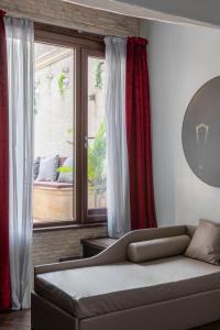 a living room with a couch in front of a window at BDB Rooms Margutta in Rome