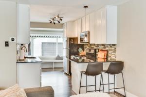 a kitchen with white cabinets and two bar stools at Pet-Friendly Salt Lake City Getaway Near Skiing! in Salt Lake City