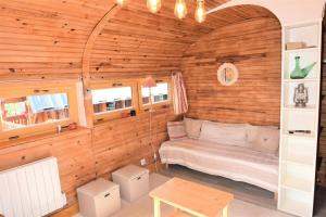 a room with a bed in a wooden wall at Chalet Schi Jaacas - Chalets pour 10 Personnes 424 in Aime-La Plagne
