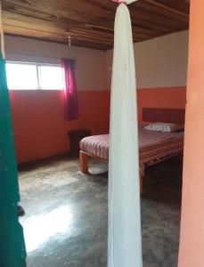 a room with a bed and a window in it at Hotel El Dorado in Tuxtla Chico