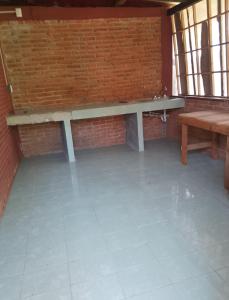 a brick wall with a bench and a table at Hotel El Dorado in Tuxtla Chico