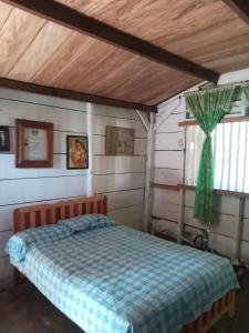 a bedroom with a bed in a house at Hotel El Dorado in Tuxtla Chico