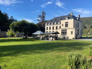 a large white building on a grass field at Domaine Chateau le Risdoux 20pers, unieke locatie in Vireux-Wallerand