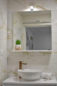 a bathroom with a white sink and a mirror at Apartmani Bire in Lumbarda