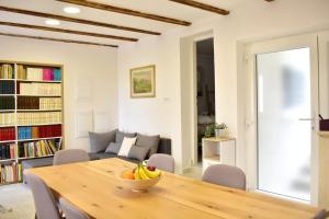 a dining room with a table with a bowl of bananas on it at Apartmani Bire in Lumbarda