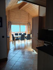 a kitchen and dining room with a table and chairs at Résidence L'oree Des Neiges - 4 Pièces pour 6 Personnes 711 in Peisey-Nancroix