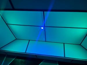 a ceiling with blue lights in a room at Ouest Nelis Lodge in Saint-Laurent du Maroni