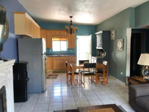 a kitchen with a table and chairs and a refrigerator at Almejas A in San Carlos