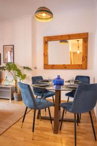 a dining room with a table and chairs and a mirror at Charming Apartment at San Bernardo Neighborhood By OUI Sevilla in Seville