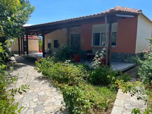 a house with a pathway in front of it at Monastiraki Villa in Keramoti +15 photos