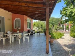 an outdoor patio with a table and chairs at Monastiraki Villa in Keramoti