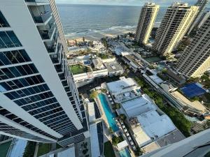 an aerial view of a city with buildings and the ocean at Hilton Surfers High Floor Beach Views in Gold Coast