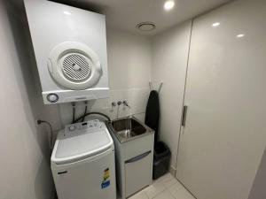 a small bathroom with a sink and a toilet at Hilton Surfers High Floor Beach Views in Gold Coast