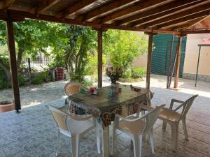 a wooden table and chairs on a patio at Monastiraki Villa in Keramoti