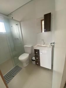 a bathroom with a toilet and a sink and a shower at MEG House Hostel in Florianópolis +40 photos