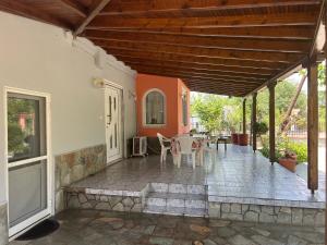 a porch of a house with a table and chairs at Monastiraki Villa in Keramoti