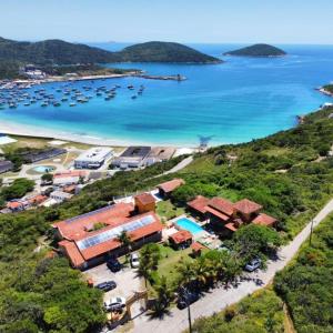 an aerial view of a resort with boats in the water at Pousada Tanto Mar in Arraial do Cabo