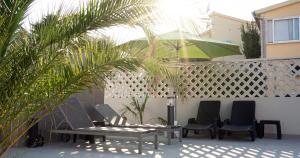 a patio with two tables and chairs and a fence at Villa Patricija in Medulin