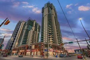 a city with tall buildings and a street with a traffic light at Monki Di Executive Suites - Alura in Calgary