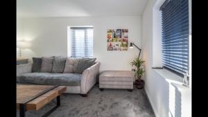 a living room with a couch and a chair at The Highfield Chester. in Chester