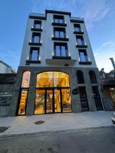 a tall building with its doors open on a street at Hotel 1920 in Podgorica