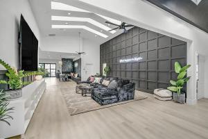 a living room with a couch and some plants at 8000sf 7BR Villa Casita Pool Spa Gym & Games in Las Vegas