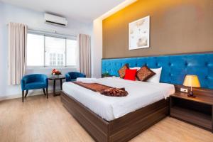 Postel nebo postele na pokoji v ubytování Khách sạn Bamboo Sài gòn + 12 fotografií