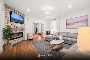 a living room with a couch and a fireplace at 4BR for 10, Near Ark, High-Tech Kitchen, Parking! in Williamstown