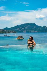 a woman sitting in the water in the ocean at Alice Tatil Evi in Marmaris