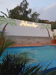 a sign for a resort with a swimming pool at ADVENTURE Hostel in San Gil