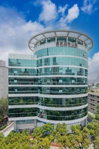 a large glass building with a dome at CM Serviced Apartment Shenzhen Dongmen in Shenzhen