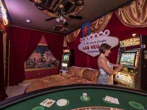 a woman standing at a poker table in a casino at 10 Acre Lakefront Game House - Sleep Upto 45 in Clermont