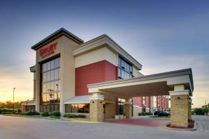 a store front of a shopping center with a garage at Drury Inn & Suites Greensboro in Greensboro