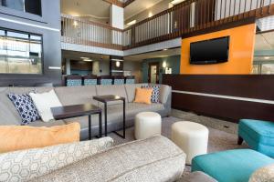 a lobby with couches and a flat screen tv at Drury Inn & Suites Greensboro in Greensboro