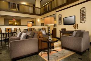 a living room with couches and a tv at Drury Inn & Suites Springfield in Springfield
