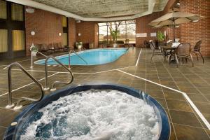 a swimming pool with a tub of water in a building at Drury Inn & Suites Springfield in Springfield