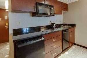 a kitchen with a sink and a microwave at Drury Inn & Suites Louisville East in Louisville