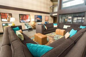 a large living room with a large couch and chairs at Drury Inn & Suites McAllen in McAllen