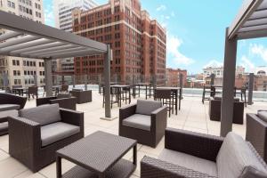 a rooftop patio with tables and chairs on a building at Drury Plaza Hotel Pittsburgh Downtown in Pittsburgh