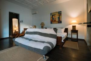 a bedroom with a bed and a living room at Villa Alizee in Port Louis