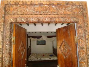 an open door into a bedroom with a bed at Paradise Beach Bungalows in Paje