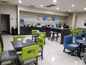 a restaurant with tables and chairs and a counter at SureStay Plus by Best Western Corydon in Corydon