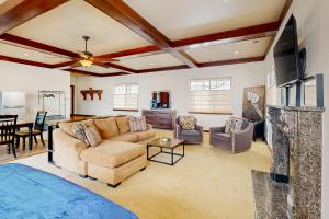 a living room with a couch and a tv at Red Rock Retreat in Fruita