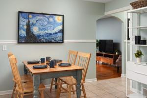 a dining room table with chairs and a painting on the wall at French Island Whot Tub, Kayak, Lake View, Ev in La Crosse
