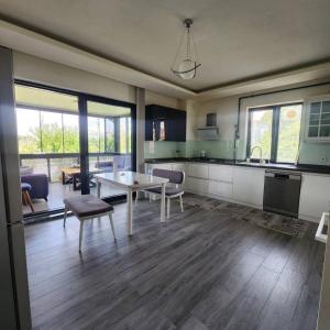 a kitchen and living room with a table and a dining room at Luxury villa in Istanbul